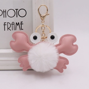 Cute pink plush crab pompom keychain with soft faux fur and gold metal lobster clasp