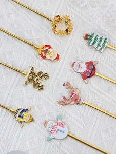 Macro detail of eight stainless steel Christmas spoons with festive enamel character charms