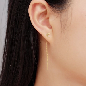 Elegant S925 sterling silver moon and star tassel earrings worn by a model in a close-up