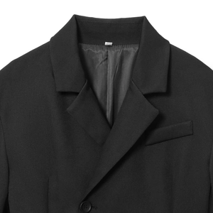 Modern oversized black blazer with sharp lapels and structured shoulders on white background