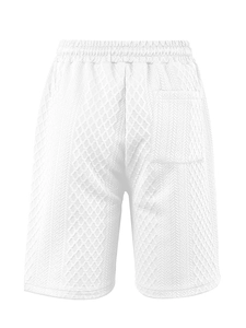 Detail of white men's shorts with 3D geometric jacquard knit texture and waistband