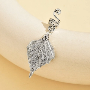 Detail of silver alloy hair ring featuring a delicate hollow leaf pendant charm