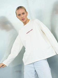Wit katoenen T-shirt met lange mouwen, rode Toxicity Coach-print en een ronde hals