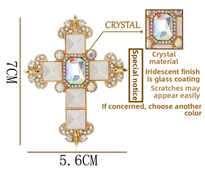 Macro detail of royal crystal cross brooch with dimensions 7cm by 5.6cm on white background