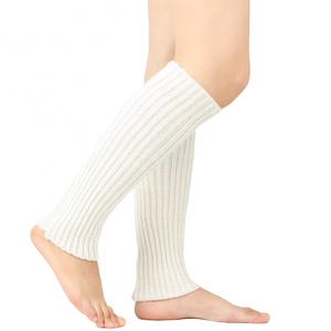 Close-up of white knitted leg warmers showing detailed rib texture and soft knit fabric