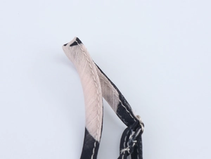 Detail of floral chiffon dress shoulder strap showing high-quality stitching and beige lining
