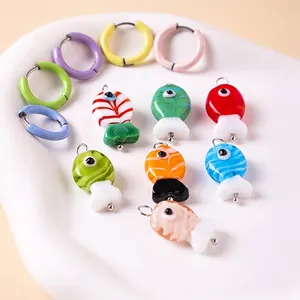 Colorful freshwater glass fish drop earrings in vibrant macaron shades on a white tray