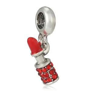 Macro shot of silver lipstick charm with red crystal rhinestones for DIY bracelets