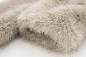 Macro shot of fluffy light brown faux fur texture showing premium soft synthetic fibers