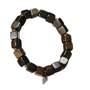 Dark brown square wood bead bracelet with gold metal spacers on white background