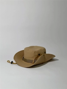 Detail view of khaki outdoor sun hat featuring metal vents and adjustable chin strap