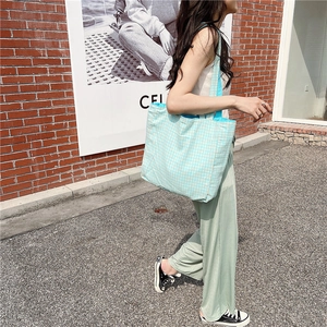 Foto exterior de un bolso tote de lona a cuadros azules y blancos de gran capacidad