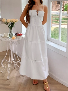 Detail view of a white tiered sundress with button-front bodice and ruffled layers