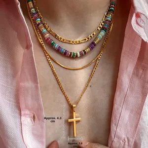 Detailed close-up of layered 18k gold plated necklace with colorful beads and cross charm