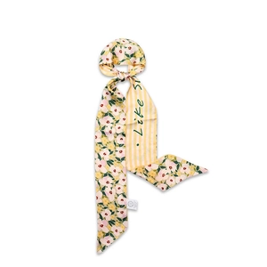 Detail of 100% silk floral scarf showing Like S print and premium fabric texture