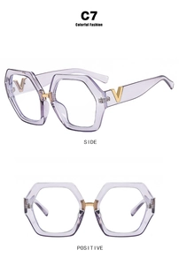 Detailed view of translucent purple hexagonal glasses frame with golden V logo on temple