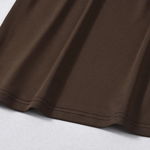 Close-up of double-needle hem stitching on a dark brown off-shoulder bodycon dress