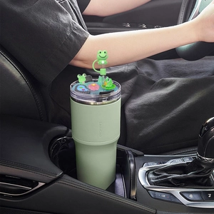 Close-up of 40oz tumbler lid with cute frog ornaments and lotus pond scene in car cup holder