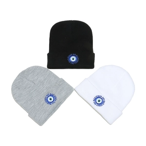 Three-piece knitted beanie set in black, grey, and white with No Bad Vibes evil eye embroidery