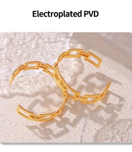 Detail of PVD gold plated geometric hollow chain cuff bracelet with a polished finish