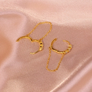 Macro shot of S925 sterling silver stamp on golden star hoop earring with chain fringe