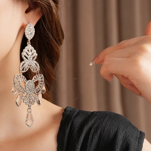 Close-up of sparkling flower drop tassel earrings with silver needle and crystals