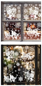 Detail of white Christmas window decals featuring Santa and snowflakes on glass panes