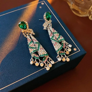 Detail of vintage silver drop earrings with multi-color rhinestones on a blue box