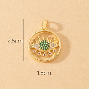 Detailed size view of evil eye pendant in gold with green crystals 2.5cm by 1.8cm