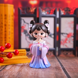 Close-up of cute cartoon girl figurines in purple and pink traditional Hanfu costumes