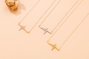 Detailed view of creative lightning and heartbeat pattern necklaces in gold, silver, and rose gold