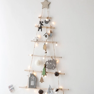 Christmas tree wall decoration made of wooden branches with LED lights and ornaments