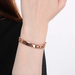 Detail of rose gold tungsten bracelet on wrist showing magnetic germanium link structure