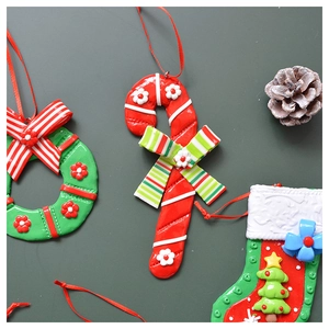 Detail of Christmas tree ornaments featuring wreath, cane and sock clay models