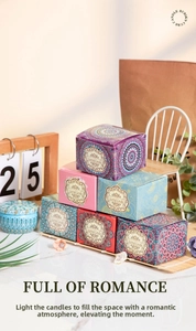 Detailed view of colorful mandala style candle tins and boxes in a warm home setting
