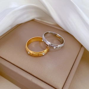 Minimalist geometric titanium steel rings in gold and silver with diamond accents on silk