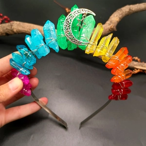 Macro detail of rainbow crystal headband with silver moon and star charms on metal wire