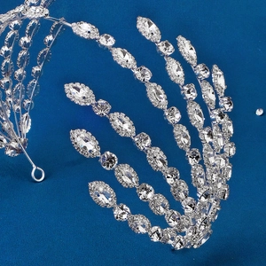 Luxury silver bridal headband with sparkling marquise crystals on a deep blue surface