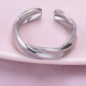 Macro shot of silver irregular textured stainless steel ring with open design