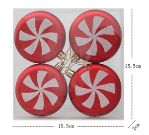 Detail of four red and white spiral peppermint Christmas ornaments in clear packaging box