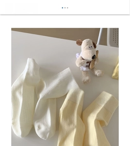 Detailed close-up of cream ribbed cotton socks showing premium vertical stripe texture