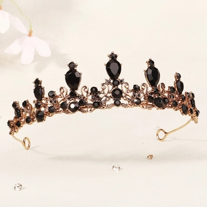 Detail of vintage gold crown with intricate black crystal inlays and baroque metalwork