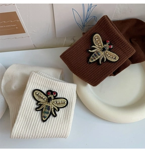 Detailed embroidery of bees with rhinestones on ribbed cotton crew socks