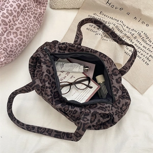 Top view of large leopard print tote bag interior showing ample storage space and zipper