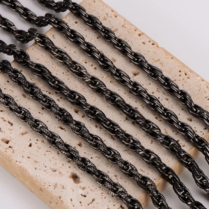 Vintage stainless steel twisted rope chains in multiple styles on a stone base