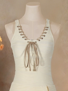 Sleeveless cream one-piece swimsuit with V-neck lace-up detail and textured fabric