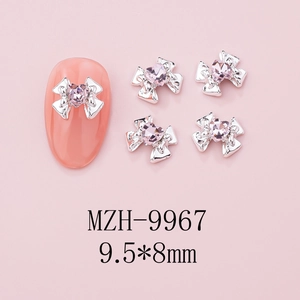 Detailed view of silver bow nail art with pink heart rhinestone, size 9.5x8mm