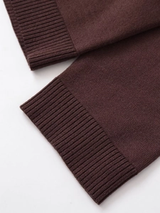 Detailed macro view of dark brown ribbed knit cuffs on women's casual set outfit