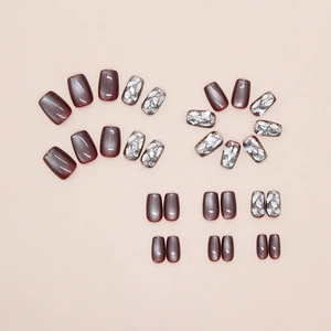 Detailed set of burgundy cat-eye press-on nails with silver glitter and butterfly accents