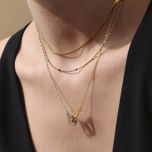 Three-layer stainless steel necklace featuring mixed-metal chains and colorful bead accents